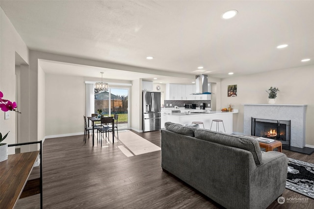 living room featuring dark hardwood / wood-style flooring and a high end fireplace