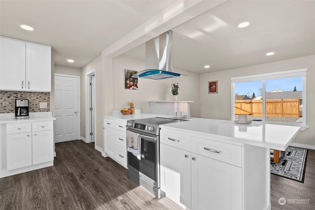 kitchen with island exhaust hood, kitchen peninsula, stainless steel range with electric cooktop, and white cabinets