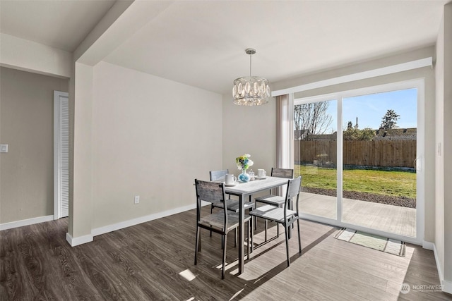 dining room featuring an inviting chandelier and dark wood-type flooring