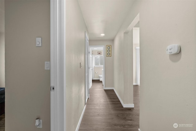 corridor with dark wood-type flooring