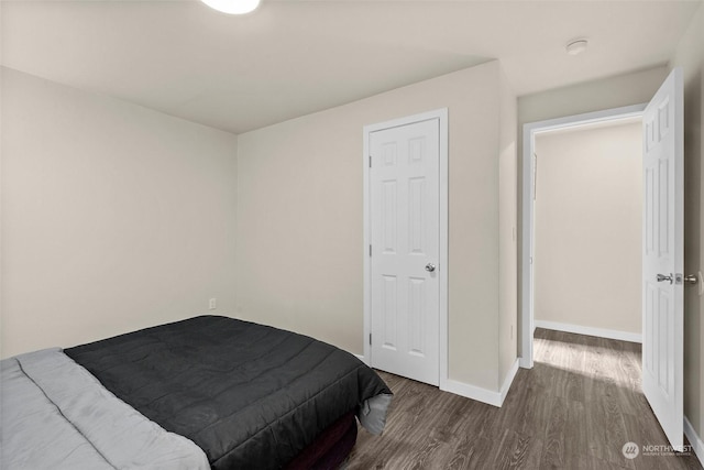 bedroom with dark hardwood / wood-style flooring