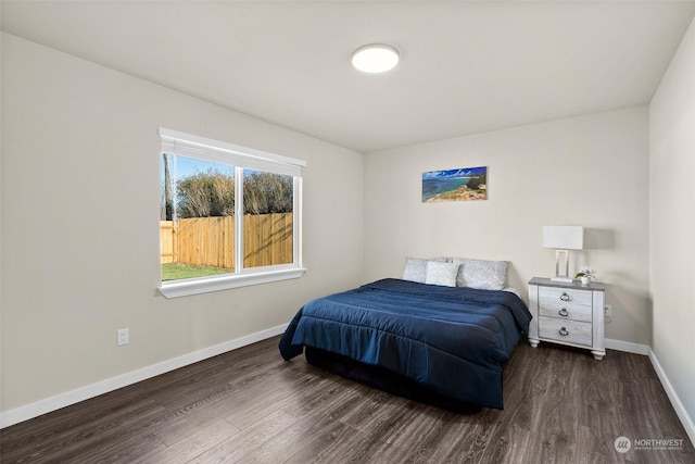 bedroom with dark hardwood / wood-style floors