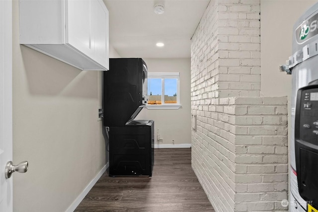 interior space featuring brick wall and dark hardwood / wood-style flooring