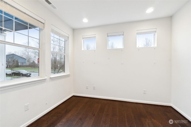 unfurnished room featuring dark wood-type flooring