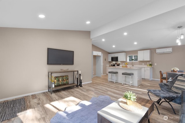 living room featuring lofted ceiling, a wall unit AC, and light hardwood / wood-style floors