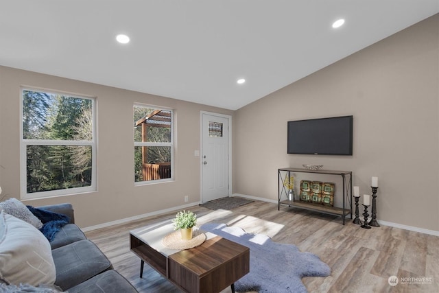 living room featuring lofted ceiling and light wood-type flooring