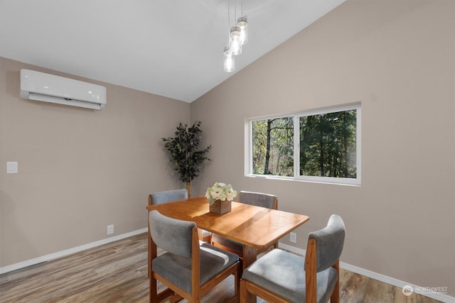 dining space with a wall mounted AC, vaulted ceiling, and light wood-type flooring