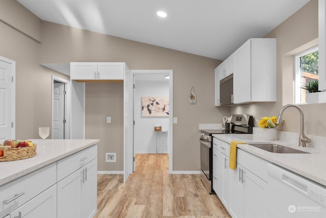 kitchen with white dishwasher, sink, stainless steel electric range, and white cabinetry