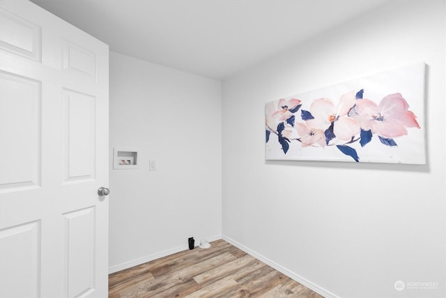 clothes washing area featuring washer hookup and light hardwood / wood-style flooring