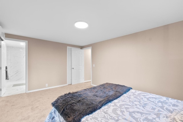 bedroom with ensuite bathroom and carpet flooring