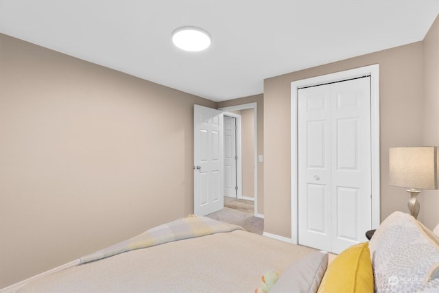 bedroom with light colored carpet and a closet