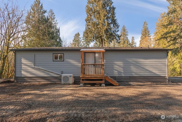 rear view of property with ac unit