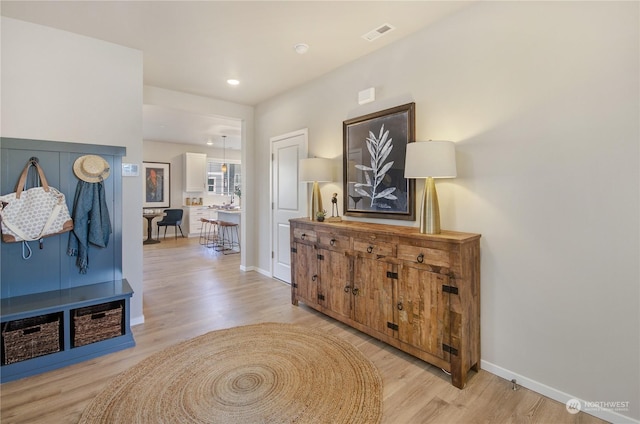 corridor with light hardwood / wood-style floors