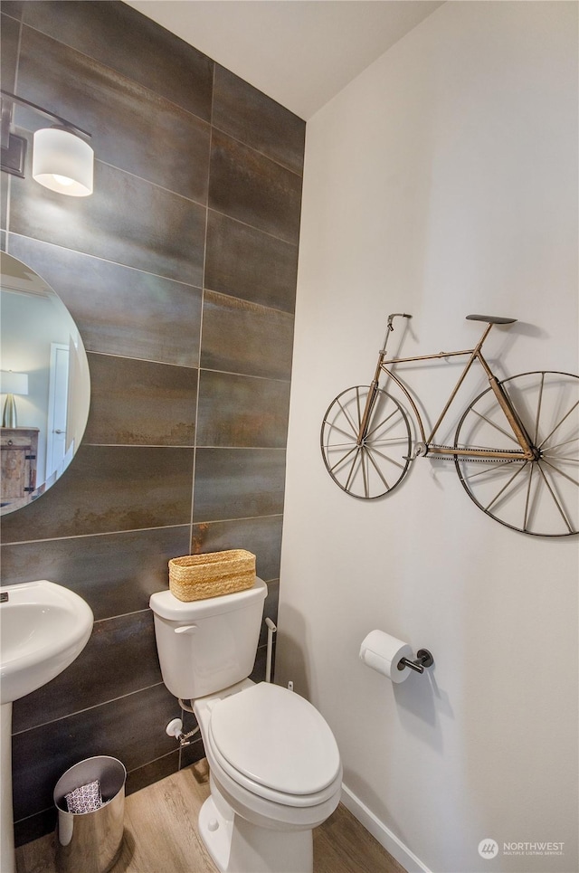 bathroom with hardwood / wood-style flooring and toilet