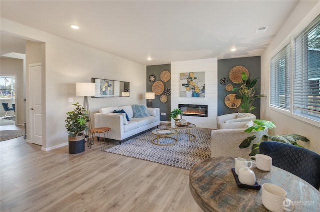 living room featuring a fireplace and light hardwood / wood-style flooring