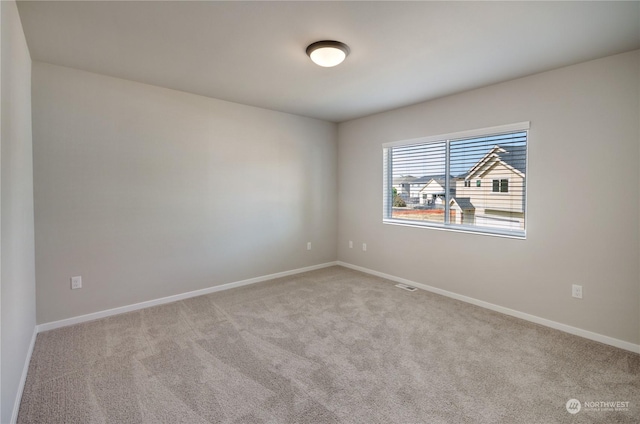 unfurnished room with light carpet