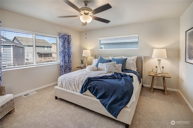 bedroom featuring light carpet and ceiling fan