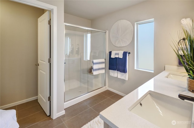 bathroom with walk in shower, tile patterned floors, and vanity