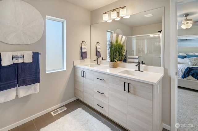 bathroom with vanity, tile patterned floors, ceiling fan, and walk in shower