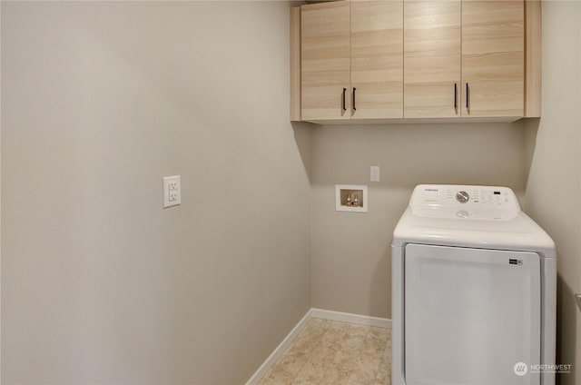 washroom featuring washer / clothes dryer and cabinets