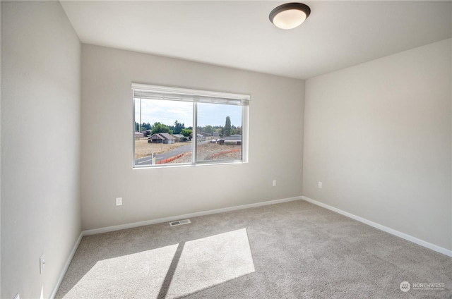 spare room with light colored carpet