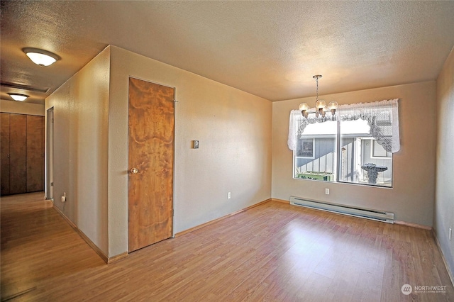 unfurnished dining area with a baseboard radiator, wood-type flooring, a chandelier, and a textured ceiling