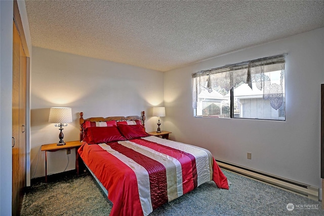 bedroom featuring carpet floors, a textured ceiling, and baseboard heating