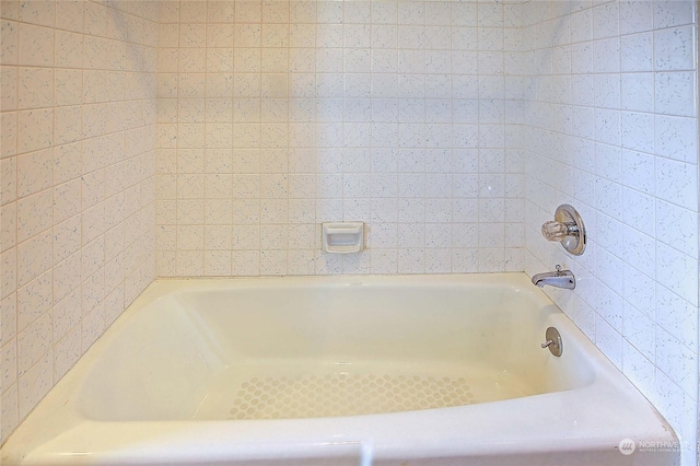 bathroom with a tub to relax in