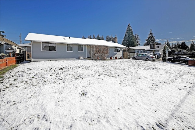 view of snow covered rear of property