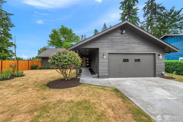 view of front of home featuring driveway, an attached garage, a front lawn, and fence