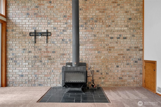 details featuring carpet flooring and a wood stove