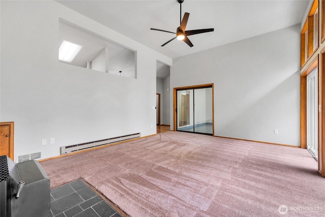 unfurnished living room with visible vents, ceiling fan, carpet, lofted ceiling, and a baseboard radiator