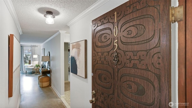 hall with a textured ceiling, baseboards, finished concrete flooring, and crown molding