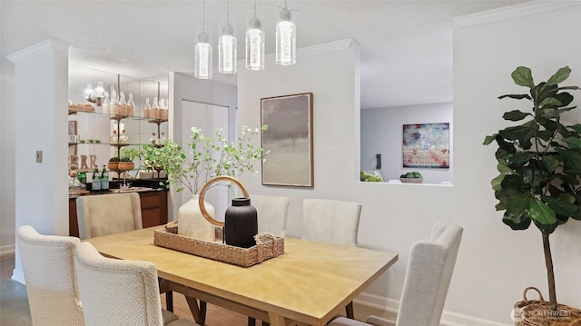 dining room featuring crown molding and baseboards