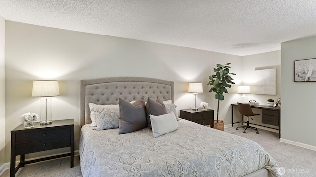 bedroom featuring a textured ceiling, carpet floors, and baseboards