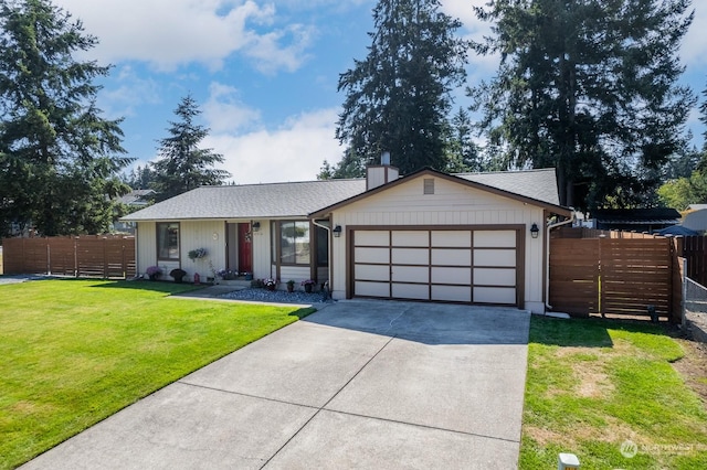 single story home featuring a garage and a front lawn