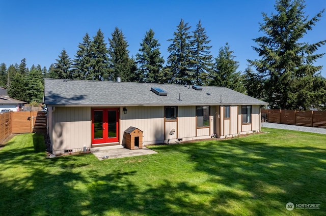 rear view of property featuring french doors and a yard