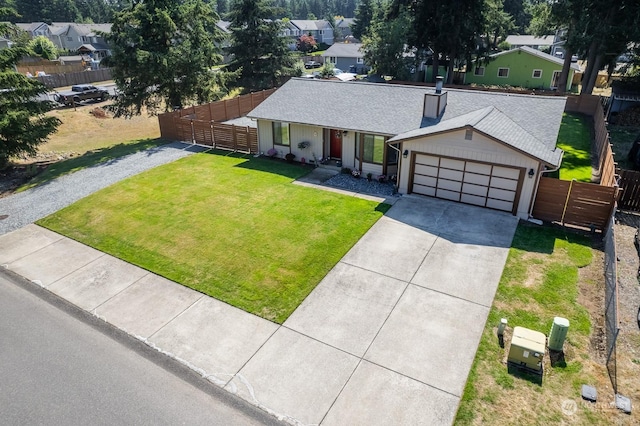 ranch-style home featuring a garage and a front lawn