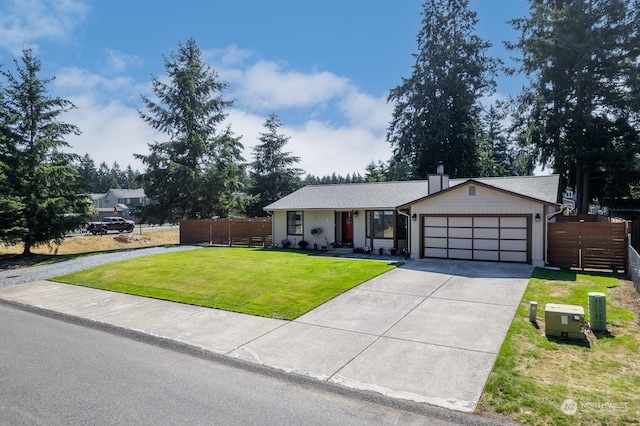 ranch-style house featuring a garage and a front lawn