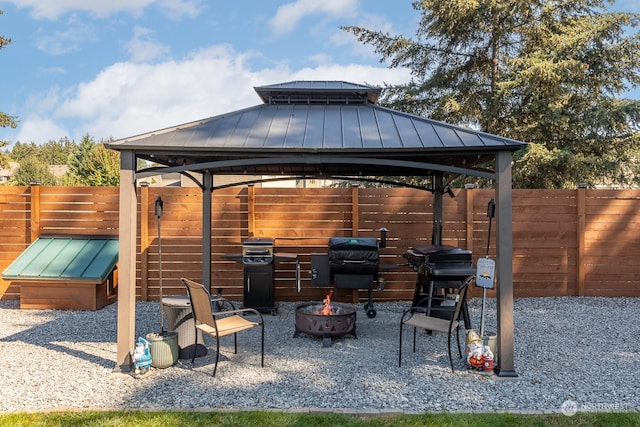 view of patio / terrace with area for grilling, a gazebo, and an outdoor fire pit