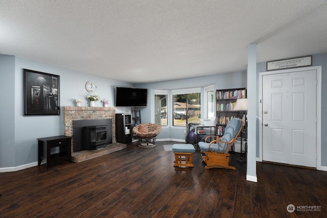 living room with dark hardwood / wood-style floors and a textured ceiling