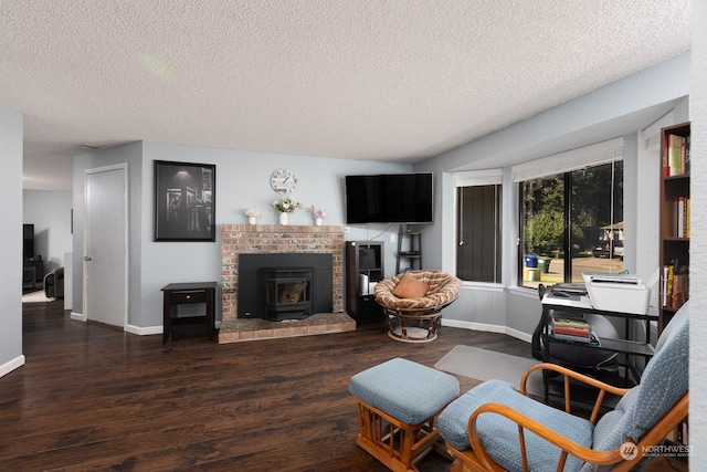 living room featuring dark hardwood / wood-style flooring, a textured ceiling, and a wood stove