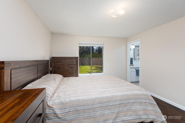 bedroom with dark hardwood / wood-style flooring and a textured ceiling