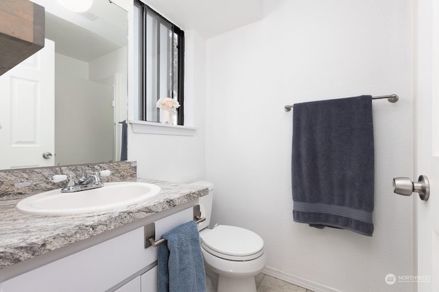 bathroom featuring tile patterned floors, vanity, and toilet