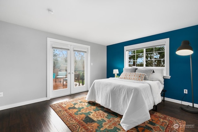 bedroom featuring multiple windows, access to exterior, dark wood-type flooring, and french doors