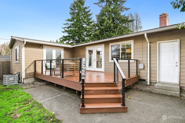 back of property featuring cooling unit, a wooden deck, and french doors