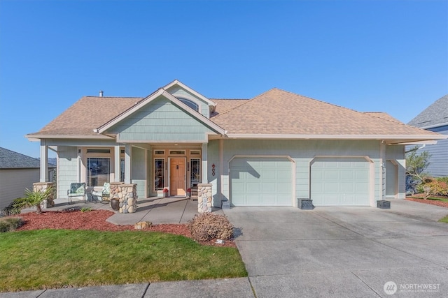 view of front of home with a garage, covered porch, a shingled roof, and concrete driveway