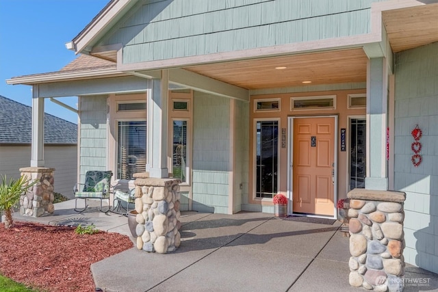 view of exterior entry featuring a porch