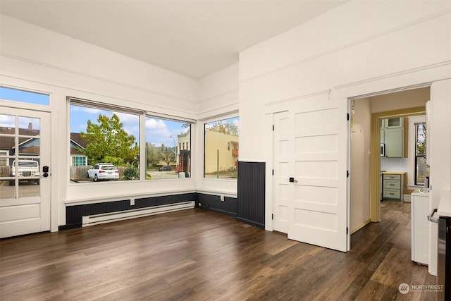 empty room featuring dark hardwood / wood-style flooring and baseboard heating