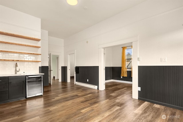 unfurnished living room with dark hardwood / wood-style floors, indoor wet bar, and wine cooler